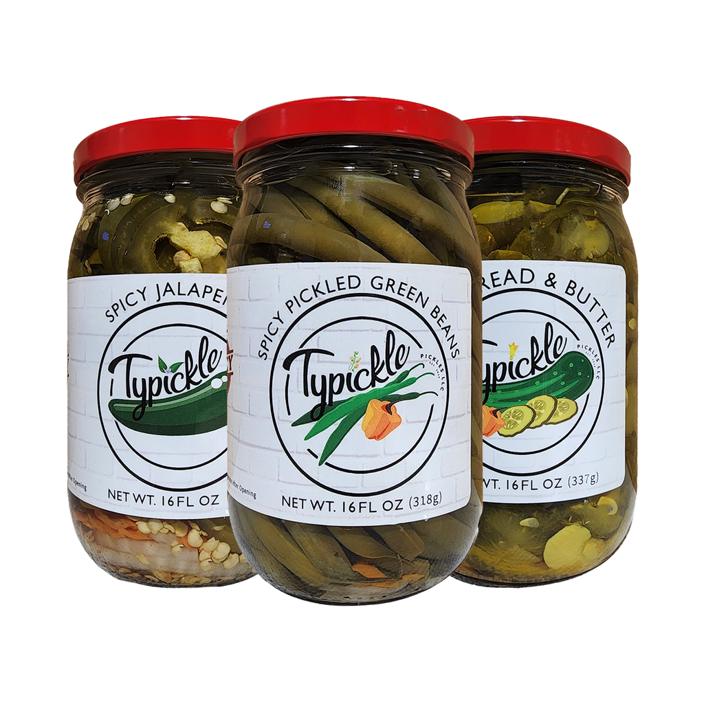 three jars of pickled green beans and other vegetables
